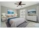 Serene bedroom with neutral tones, decorative artwork, and ample natural light from the windows at 10867 Garden Oaks Ln, Charlotte, NC 28273