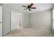 Neutral bedroom shows entrance to a closet and an additional room at 10867 Garden Oaks Ln, Charlotte, NC 28273