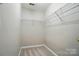 Walk-in closet with carpet and metal shelving for storage at 10867 Garden Oaks Ln, Charlotte, NC 28273
