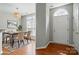 Bright dining area featuring modern lighting, stylish furnishings, and beautiful wood flooring at 10867 Garden Oaks Ln, Charlotte, NC 28273
