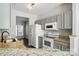 Well-equipped kitchen with granite counters, modern appliances, and grey cabinetry at 10867 Garden Oaks Ln, Charlotte, NC 28273