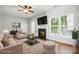 Inviting living room with a fireplace, plush seating, and large windows offering abundant natural light at 10867 Garden Oaks Ln, Charlotte, NC 28273