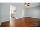 Open living area with hardwood floors and a view of the modern kitchen at 10867 Garden Oaks Ln, Charlotte, NC 28273