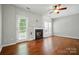 Bright living room with hardwood floors, fireplace, and lots of natural light at 10867 Garden Oaks Ln, Charlotte, NC 28273