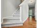 Carpeted staircase leading to the upper level, complemented by neutral wall colors and wood accents at 10867 Garden Oaks Ln, Charlotte, NC 28273