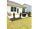 Backyard patio features a fire pit, seating, and well-maintained landscaping, perfect for outdoor entertaining at 110 White Apple Way, Statesville, NC 28625