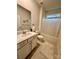 Bright bathroom with a single vanity, neutral tile, and shower-tub combo at 110 White Apple Way, Statesville, NC 28625