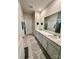 Bathroom with double sink vanity, large mirror, tile floor and white cabinets at 110 White Apple Way, Statesville, NC 28625