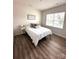 Bright bedroom features wood flooring, natural light, and a cozy design perfect for relaxation and comfort at 110 White Apple Way, Statesville, NC 28625