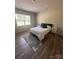 Comfortable bedroom with a queen bed, wood-look floors, a window, and modern nightstands at 110 White Apple Way, Statesville, NC 28625