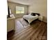 Bedroom with neutral walls, wood-look flooring, area rug and natural light from window at 110 White Apple Way, Statesville, NC 28625
