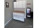 Organized garage featuring a rolling workbench, overhead cabinets, epoxy flooring, and a Bud Light mini-fridge at 110 White Apple Way, Statesville, NC 28625