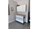 Well-organized garage with a rolling work bench, overhead cabinets, and epoxy flooring at 110 White Apple Way, Statesville, NC 28625