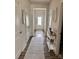 Inviting hallway featuring wood floors, neutral paint, and a decorative console table that creates a warm and welcoming ambiance at 110 White Apple Way, Statesville, NC 28625