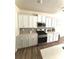 Modern kitchen with stainless steel appliances, white cabinets, and sleek countertops at 110 White Apple Way, Statesville, NC 28625