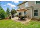 Charming backyard featuring a stone patio with dining set, perfect for outdoor entertaining at 11070 River Oaks Nw Dr, Concord, NC 28027