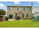 Spacious backyard with a patio, outdoor dining set, lush lawn, and a play set at 11070 River Oaks Nw Dr, Concord, NC 28027