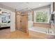 Bathroom with a tiled glass shower, soaking tub, and bright window at 11070 River Oaks Nw Dr, Concord, NC 28027