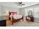 Bright bedroom featuring a ceiling fan, natural light, and a wooden vanity at 11070 River Oaks Nw Dr, Concord, NC 28027