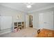 Spacious bedroom with built-in storage, neutral walls and carpet and a white ceiling fan at 11070 River Oaks Nw Dr, Concord, NC 28027