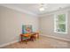 Well-lit bedroom, neutral carpet, window with blinds, and a desk perfect for a play room at 11070 River Oaks Nw Dr, Concord, NC 28027