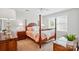 Bright bedroom featuring a four-poster bed, wooden furniture, and natural light from the window at 11070 River Oaks Nw Dr, Concord, NC 28027