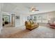 Upstairs bonus room with multiple windows, carpet floors, and a doorway leading to another room at 11070 River Oaks Nw Dr, Concord, NC 28027