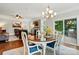 An open dining room with lots of natural light, wood floors and a modern light fixture at 11070 River Oaks Nw Dr, Concord, NC 28027