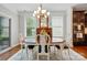 Bright dining room features wood floors, a round dining table and lots of natural light from the windows at 11070 River Oaks Nw Dr, Concord, NC 28027