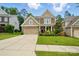 Inviting two-story home with a manicured lawn, beautiful landscaping, and a two-car garage at 11070 River Oaks Nw Dr, Concord, NC 28027