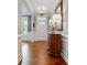 Elegant foyer with hardwood floors, wainscoting, and a decorative table with a stylish mirror at 11070 River Oaks Nw Dr, Concord, NC 28027