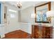 Bright foyer with hardwood floors, wainscoting detail, chandelier, and decorative furnishings at 11070 River Oaks Nw Dr, Concord, NC 28027