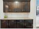 Kitchen counter with granite countertops, tile backsplash, and dark wood cabinets at 11070 River Oaks Nw Dr, Concord, NC 28027