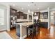 Modern kitchen with stainless steel appliances, granite countertops, and dark wood cabinets and hardwood floors at 11070 River Oaks Nw Dr, Concord, NC 28027