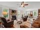 Open-concept living room featuring a fireplace, hardwood floors, and a view to the dining area at 11070 River Oaks Nw Dr, Concord, NC 28027