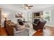 Cozy living room with fireplace, hardwood floors, and comfortable seating at 11070 River Oaks Nw Dr, Concord, NC 28027