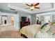 Open main bedroom with a large bed, a dresser with a TV, and access to a walk-in closet at 11070 River Oaks Nw Dr, Concord, NC 28027