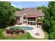 Stunning backyard oasis with inground pool, stone patio, pergola, and lush landscaping at 1108 Shinnecock Ln, Waxhaw, NC 28173