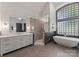 Elegant bathroom features a soaking tub, glass shower, and stylish vanity at 1108 Shinnecock Ln, Waxhaw, NC 28173