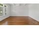 Bright, open bedroom with hardwood floors, large window, and plantation shutters at 1108 Shinnecock Ln, Waxhaw, NC 28173