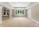 Bright bonus room with backyard view, large window, and neutral carpet at 1108 Shinnecock Ln, Waxhaw, NC 28173