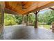Spacious covered patio with stained wood ceiling, stone columns, and an iron railing at 1108 Shinnecock Ln, Waxhaw, NC 28173