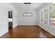Elegant dining room with hardwood floors, wainscoting, and modern chandelier at 1108 Shinnecock Ln, Waxhaw, NC 28173