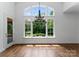 Dining room features hardwood floors, large windows with a view, and pendant lighting at 1108 Shinnecock Ln, Waxhaw, NC 28173
