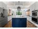 Stunning kitchen features a large island, stainless steel appliances, and designer lighting at 1108 Shinnecock Ln, Waxhaw, NC 28173