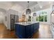 Bright kitchen featuring a large island, stainless steel appliances, and hardwood floors at 1108 Shinnecock Ln, Waxhaw, NC 28173