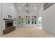 Bright living room with stone fireplace, built-in shelves, large windows, and vaulted ceilings at 1108 Shinnecock Ln, Waxhaw, NC 28173