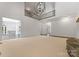 Large, open living room with fireplace, overhead lighting, and views to other rooms at 1108 Shinnecock Ln, Waxhaw, NC 28173