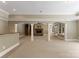 Open-concept living room with stone fireplace, support columns and bar for entertaining at 1108 Shinnecock Ln, Waxhaw, NC 28173