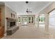 Spacious living room featuring a stone fireplace and large windows with backyard view at 1108 Shinnecock Ln, Waxhaw, NC 28173